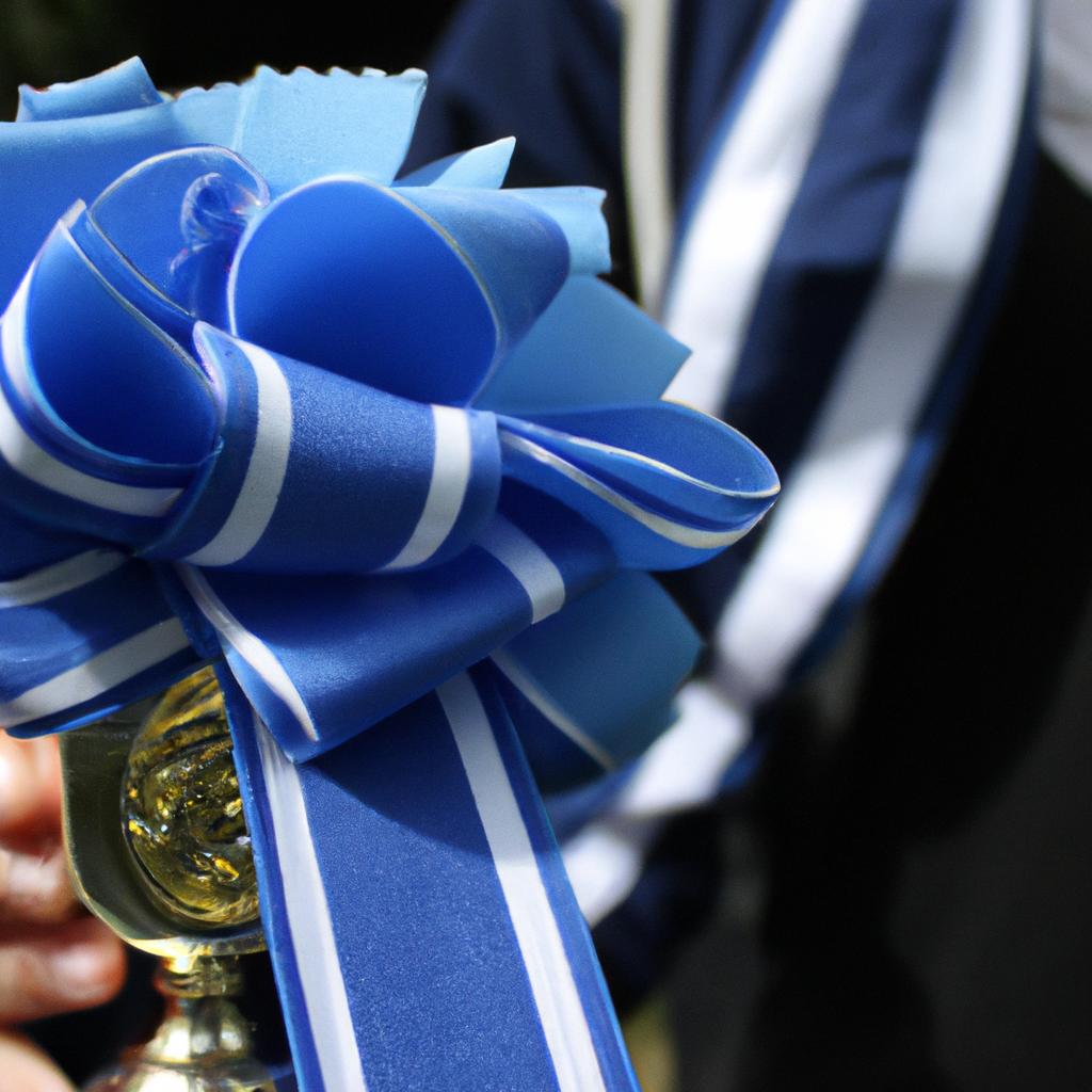 Person holding blue ribbon trophy